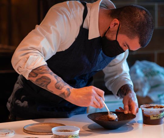 Chef Cody Auger delicately plates a dish before delivering to diners.