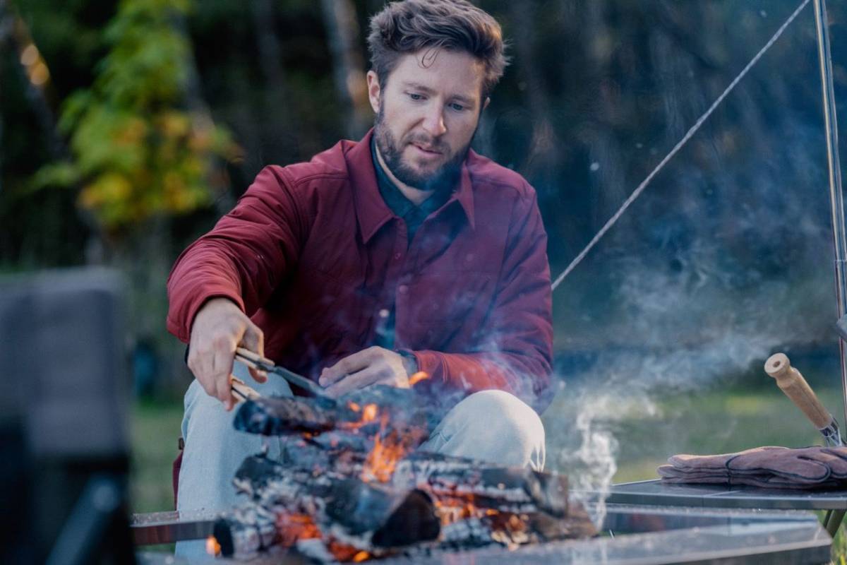 man cooking at igt camp kitchen